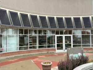 Commercial Bahama shutters installed on building in the Twin Cities