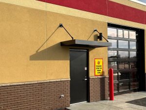 Custom metal canopy installed on building exterior in Minnesota