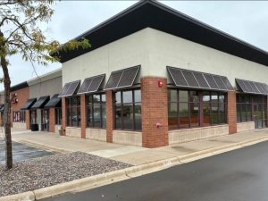Aluminum Bahama shutters providing shade and storm protection in Minnesota