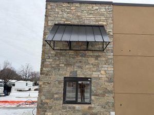 Industrial metal awning for exterior building protection in Minnesota