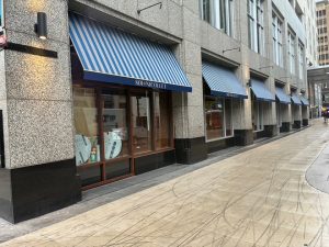 Restaurant patio fabric awning providing shade in Minnesota